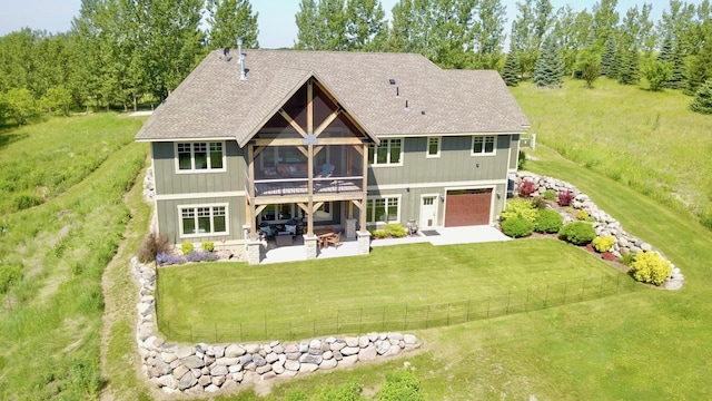 26888 734th Ave, Dassel Twp, MN 55325 - rear view of house with a patio, roof with shingles, a yard, and an attached garage