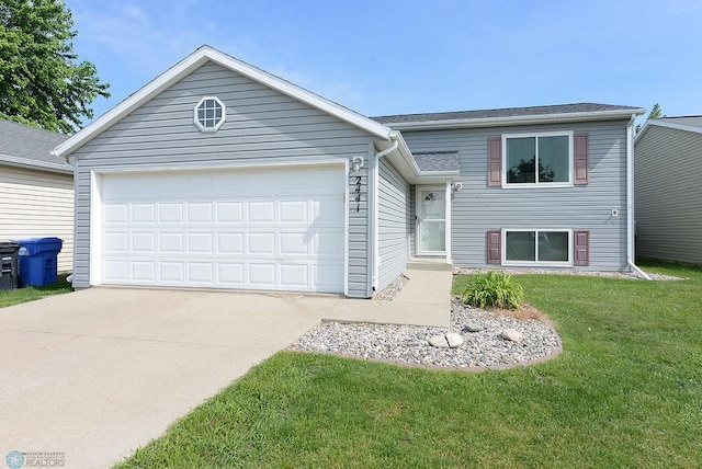2441 60th Ave S, Fargo, ND 58104 - tri-level home with concrete driveway, a garage, and a front lawn