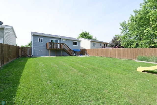2441 60th Ave S, Fargo, ND 58104 - back of property with a fenced backyard, stairs, and a deck