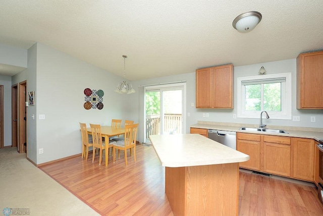 2441 60th Ave S, Fargo, ND 58104 - kitchen with light wood-style floors, light countertops, a center island, dishwasher, and decorative light fixtures