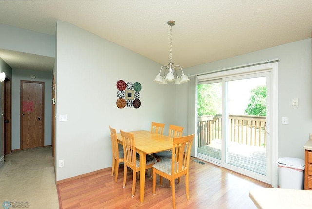 2441 60th Ave S, Fargo, ND 58104 - dining area with a chandelier and light wood finished floors