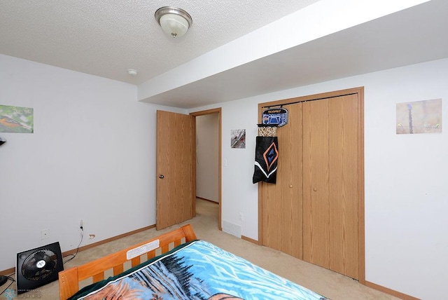 2441 60th Ave S, Fargo, ND 58104 - bedroom with light colored carpet, a textured ceiling, and a closet