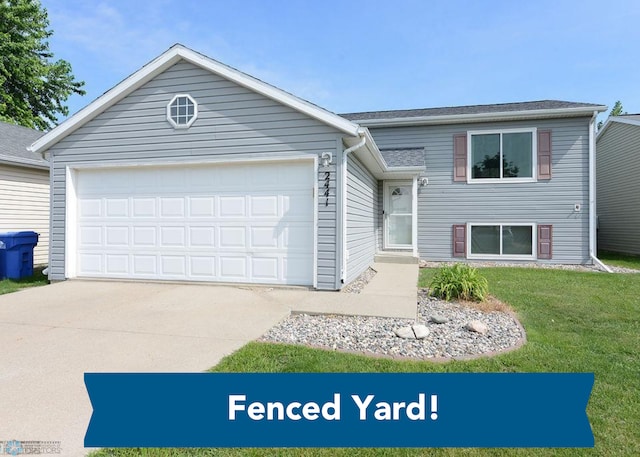 2441 60th Ave S, Fargo, ND 58104 - split level home featuring a garage, driveway, and a front lawn