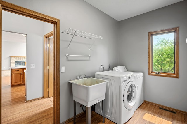 8798 Fountain Ln N, Maple Grove, MN 55311 - laundry area featuring washer and dryer and light wood finished floors