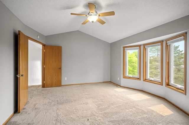 8798 Fountain Ln N, Maple Grove, MN 55311 - carpeted empty room with vaulted ceiling, a ceiling fan, and a textured ceiling