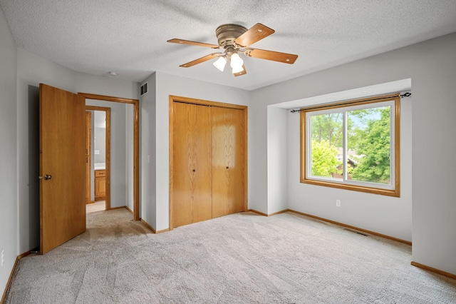 8798 Fountain Ln N, Maple Grove, MN 55311 - unfurnished bedroom with a closet, light colored carpet, a textured ceiling, and ceiling fan