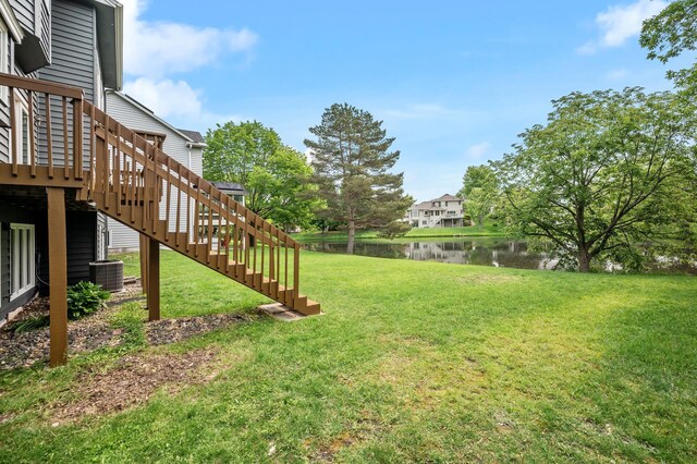 8798 Fountain Ln N, Maple Grove, MN 55311 - view of green lawn featuring a deck with water view and stairs