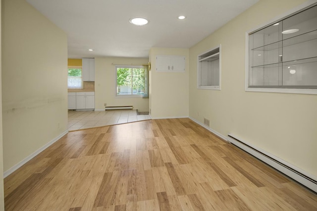 4901 99th St, Bloomington, MN 55437 - empty room featuring a baseboard radiator, light wood-type flooring, and recessed lighting
