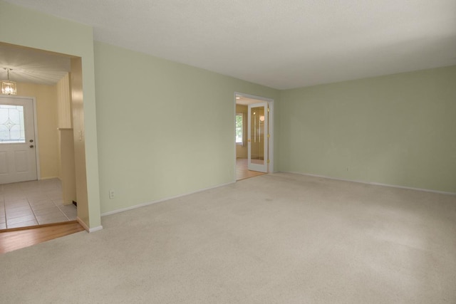 4901 99th St, Bloomington, MN 55437 - empty room with carpet flooring and a chandelier