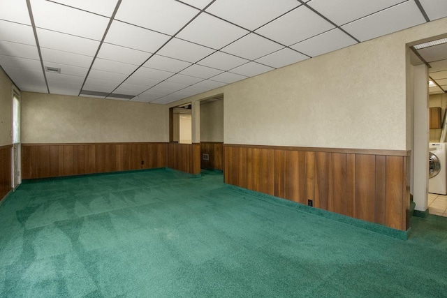 4901 99th St, Bloomington, MN 55437 - carpeted empty room featuring a wainscoted wall, washer / clothes dryer, wooden walls, and a drop ceiling