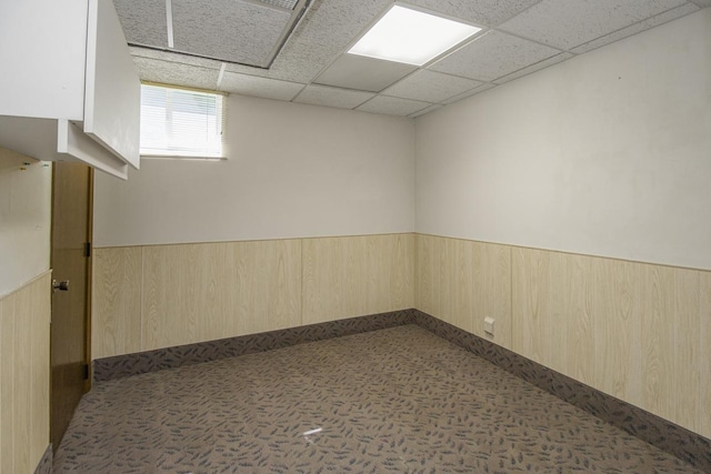 4901 99th St, Bloomington, MN 55437 - below grade area featuring wainscoting, a paneled ceiling, and wood walls