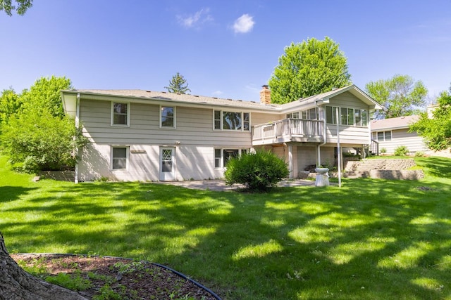 4901 99th St, Bloomington, MN 55437 - back of house with a chimney, a yard, a sunroom, and a deck