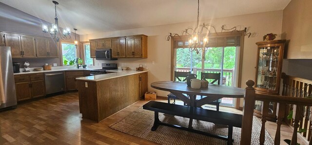 1284 Otter Ridge Rd, White Bear Twp, MN 55110 - kitchen featuring a chandelier, appliances with stainless steel finishes, a peninsula, lofted ceiling, and healthy amount of natural light
