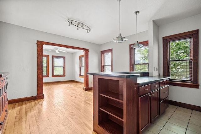 1812 Clinton Ave Unit 203, Minneapolis, MN 55404 - kitchen featuring dark countertops, pendant lighting, light wood-type flooring, and open shelves
