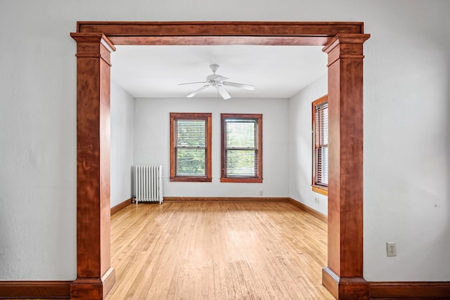 1812 Clinton Ave Unit 203, Minneapolis, MN 55404 - spare room featuring radiator heating unit, light wood finished floors, and ceiling fan
