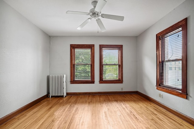 1812 Clinton Ave Unit 203, Minneapolis, MN 55404 - unfurnished room with radiator, light wood-style flooring, and ceiling fan