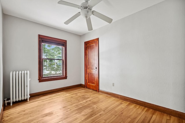 1812 Clinton Ave Unit 203, Minneapolis, MN 55404 - unfurnished room with radiator, light wood-style flooring, and a ceiling fan