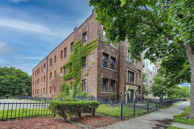 1812 Clinton Ave Unit 203, Minneapolis, MN 55404 - view of building exterior with a fenced front yard