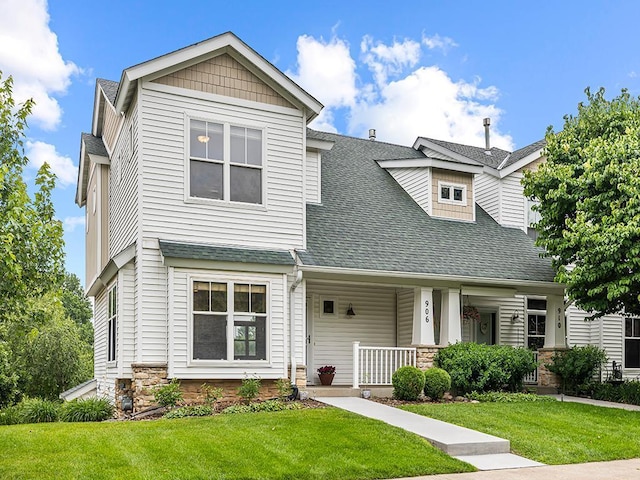 906 New Century Blvd S, Maplewood, MN 55119 - craftsman-style home featuring roof with shingles, a front lawn, covered porch, and stone siding