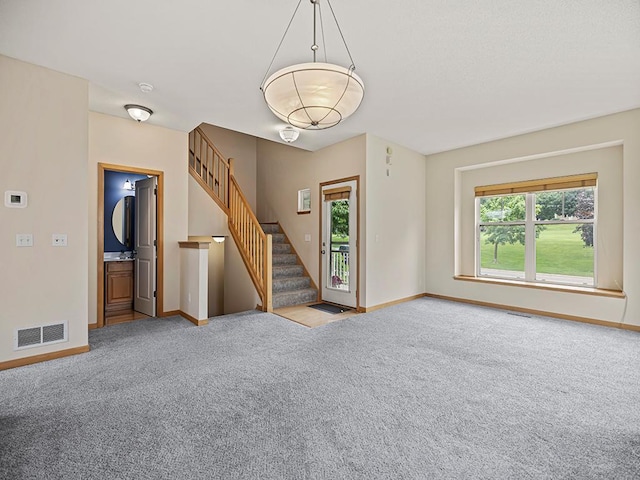 906 New Century Blvd S, Maplewood, MN 55119 - unfurnished living room featuring carpet and stairway