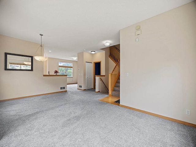 906 New Century Blvd S, Maplewood, MN 55119 - unfurnished living room featuring carpet flooring and stairs