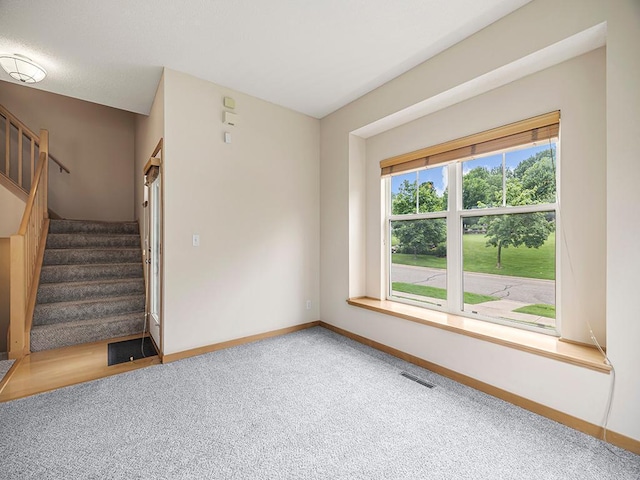 906 New Century Blvd S, Maplewood, MN 55119 - spare room featuring carpet flooring and stairs