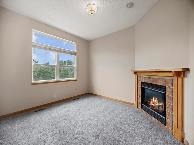 906 New Century Blvd S, Maplewood, MN 55119 - unfurnished living room featuring carpet flooring, a tile fireplace, and a textured ceiling