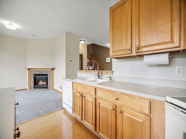 906 New Century Blvd S, Maplewood, MN 55119 - kitchen featuring white dishwasher, light wood-type flooring, light countertops, a fireplace, and range