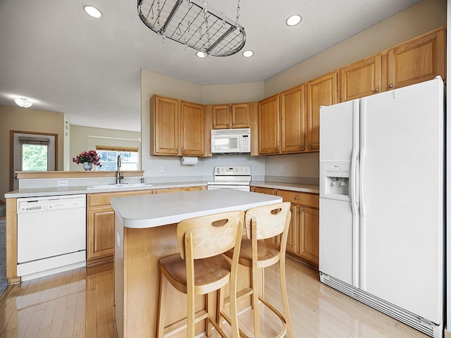 906 New Century Blvd S, Maplewood, MN 55119 - kitchen featuring white appliances, light countertops, a kitchen island, recessed lighting, and light wood-style flooring
