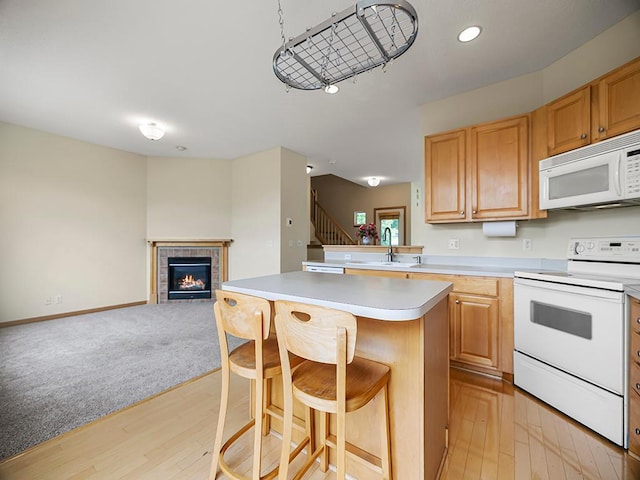 906 New Century Blvd S, Maplewood, MN 55119 - kitchen with white appliances, open floor plan, light countertops, a kitchen breakfast bar, and light wood-style floors