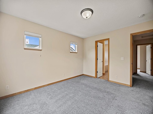 906 New Century Blvd S, Maplewood, MN 55119 - unfurnished bedroom featuring multiple windows, carpet flooring, and a textured ceiling