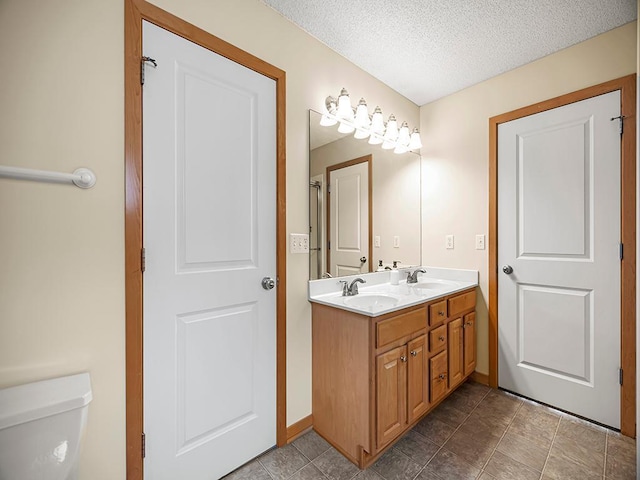 906 New Century Blvd S, Maplewood, MN 55119 - bathroom featuring double vanity, a textured ceiling, and tile patterned flooring