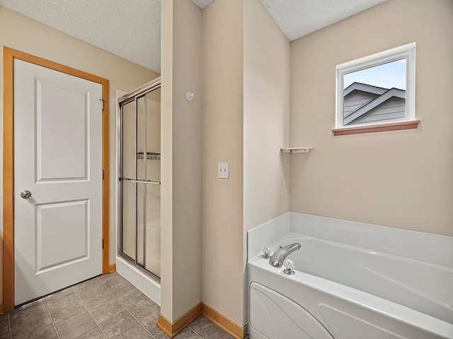 906 New Century Blvd S, Maplewood, MN 55119 - bathroom with a bath, a shower stall, and a textured ceiling