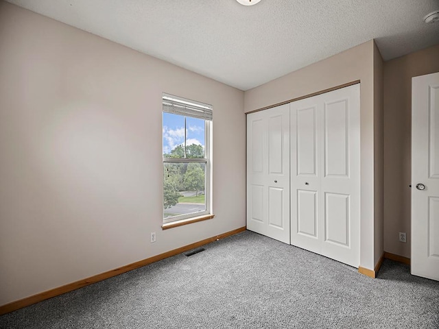 906 New Century Blvd S, Maplewood, MN 55119 - unfurnished bedroom with carpet floors, a closet, and a textured ceiling