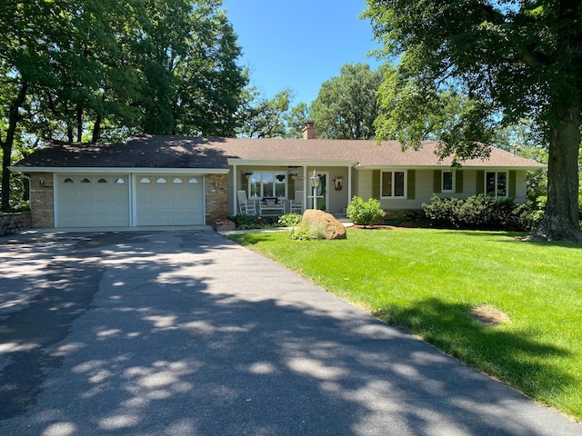69497 233rd St, Dassel, MN 55325 - ranch-style home with a front yard, asphalt driveway, a chimney, an attached garage, and a porch