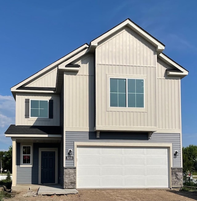 3218 Kady Ave NE, Saint Michael, MN 55376 - view of front of house with an attached garage, stone siding, and board and batten siding