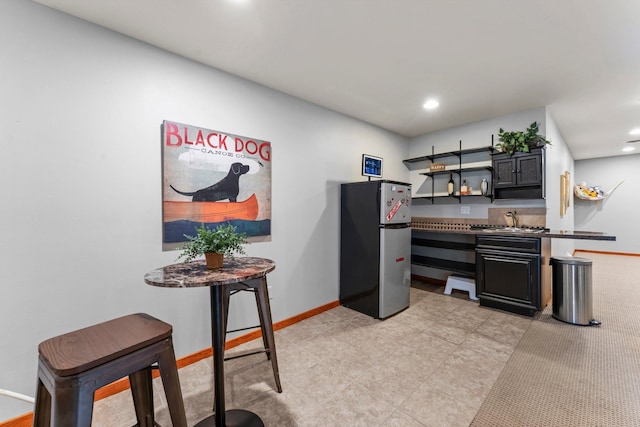 1905 Abby Rd, Cumberland, WI 54829 - kitchen with freestanding refrigerator, open shelves, dark countertops, recessed lighting, and light tile patterned floors