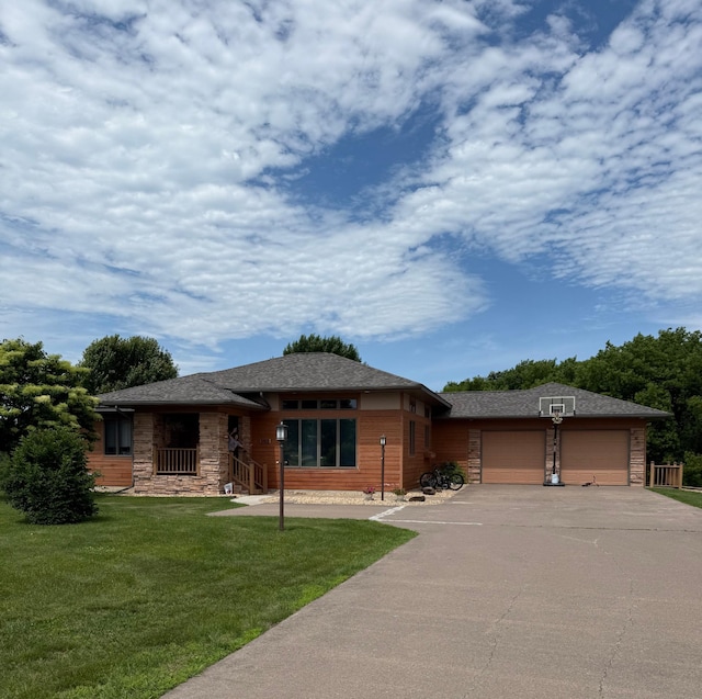 1905 Abby Rd, Cumberland, WI 54829 - view of front of house featuring a garage, a front yard, driveway, and stone siding