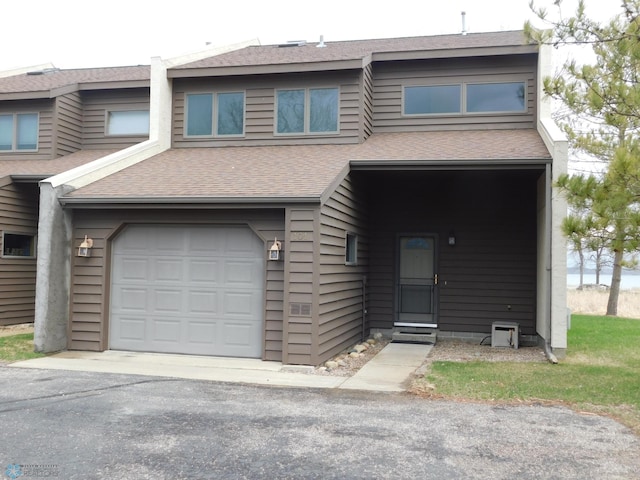 42710 County Highway 56 Unit 101, Toad Lake Twp, MN 56544 - view of property with an attached garage, a shingled roof, and asphalt driveway