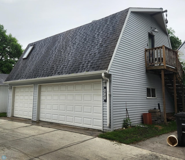 429 9th Ave S, Fargo, ND 58103 - view of side of property featuring a shingled roof, a balcony, and a garage