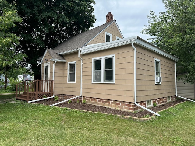 551 Center St, Tracy, MN 56175 - view of property exterior with a chimney, a lawn, and roof with shingles