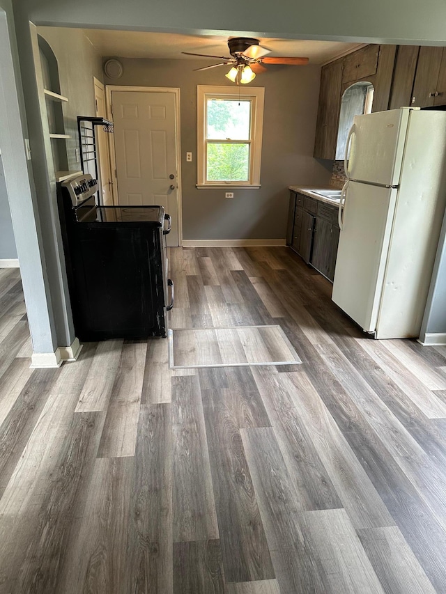 551 Center St, Tracy, MN 56175 - kitchen featuring freestanding refrigerator, stainless steel electric range, a ceiling fan, and wood finished floors