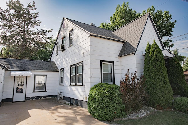 462 Saint Charles St, Winona, MN 55987 - view of side of home featuring roof with shingles and a patio area