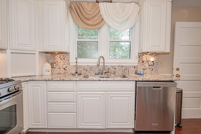 462 Saint Charles St, Winona, MN 55987 - kitchen with appliances with stainless steel finishes, white cabinetry, and decorative backsplash