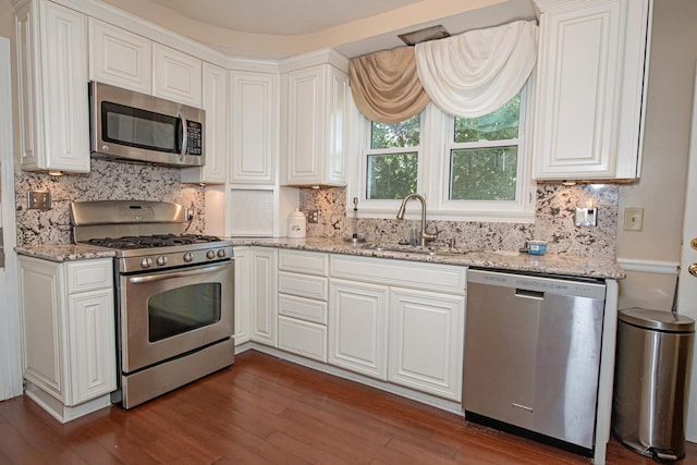 462 Saint Charles St, Winona, MN 55987 - kitchen featuring stainless steel appliances, dark wood-style floors, and tasteful backsplash