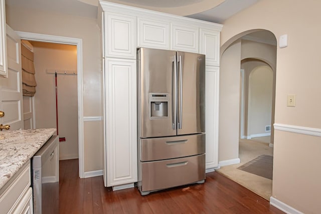 462 Saint Charles St, Winona, MN 55987 - kitchen with stainless steel appliances, arched walkways, white cabinetry, and dark wood-style flooring