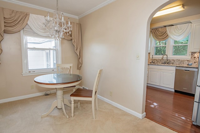 462 Saint Charles St, Winona, MN 55987 - dining space with a chandelier, crown molding, arched walkways, and light carpet