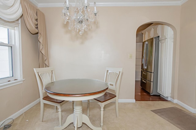 462 Saint Charles St, Winona, MN 55987 - dining area featuring arched walkways, healthy amount of natural light, a chandelier, and ornamental molding