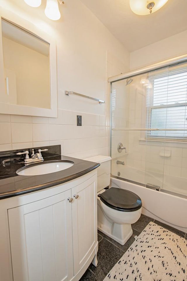 462 Saint Charles St, Winona, MN 55987 - full bath featuring tile walls, vanity, and combined bath / shower with glass door