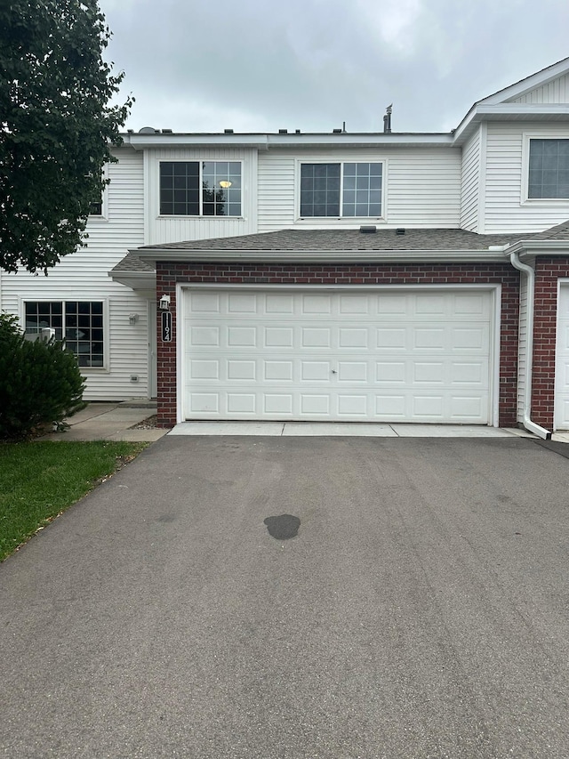 1194 Highpoint Curv, Shakopee, MN 55379 - townhome / multi-family property with brick siding, asphalt driveway, and a garage